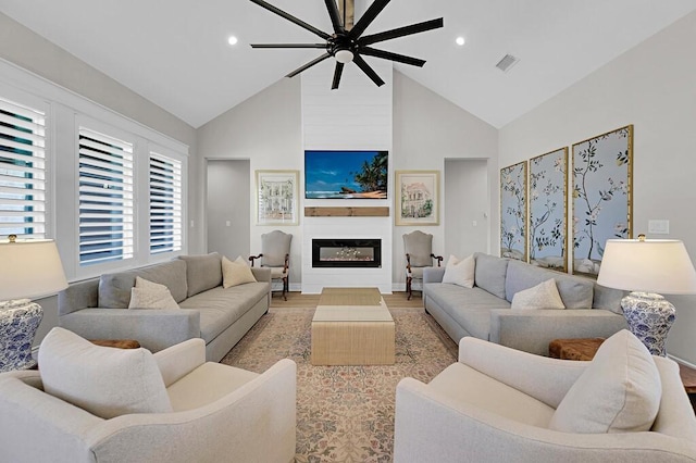 living room with visible vents, recessed lighting, a fireplace, light wood-style floors, and high vaulted ceiling