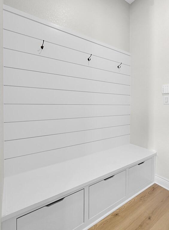 mudroom with baseboards and light wood-style floors