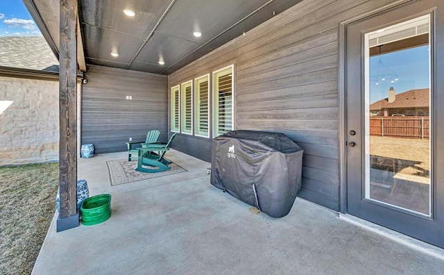 view of patio featuring grilling area and fence