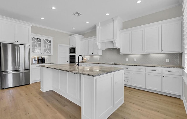 kitchen with visible vents, white cabinetry, stainless steel appliances, and crown molding