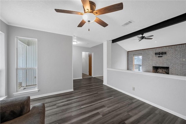 unfurnished living room with vaulted ceiling with beams, dark hardwood / wood-style floors, a brick fireplace, and ceiling fan