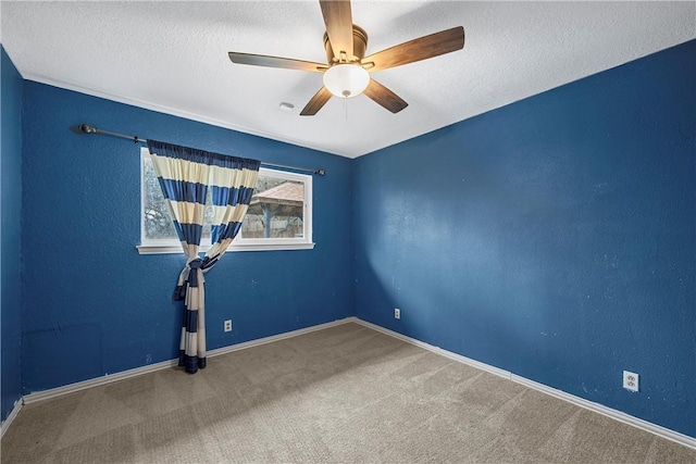 empty room featuring carpet flooring, ceiling fan, and a textured ceiling