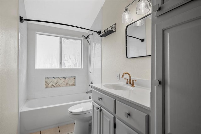 full bathroom featuring tiled shower / bath combo, tile patterned flooring, lofted ceiling, toilet, and vanity