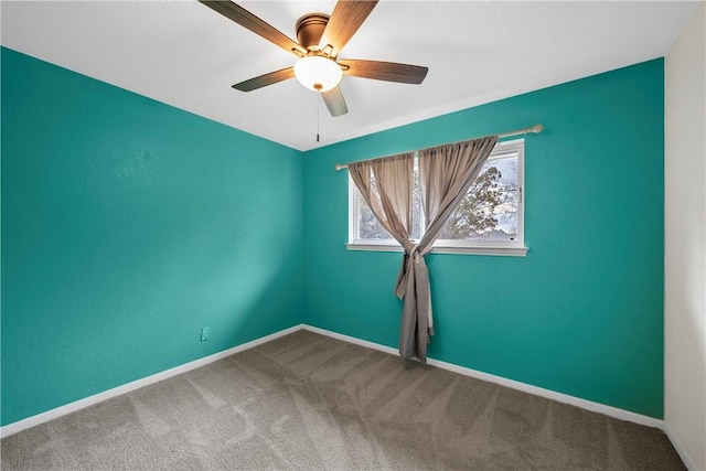 carpeted empty room featuring ceiling fan