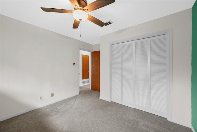 unfurnished bedroom featuring carpet, ceiling fan, and a closet