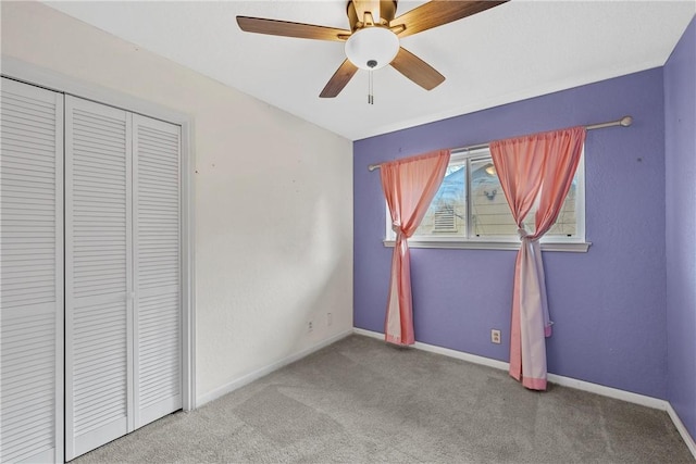 unfurnished bedroom with carpet flooring, a closet, and ceiling fan