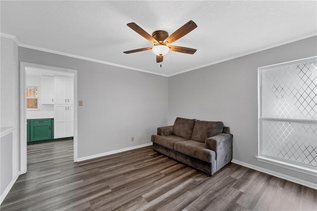 living area featuring crown molding, ceiling fan, and dark wood-type flooring