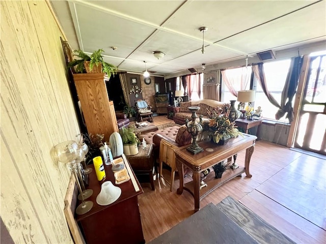 living room with hardwood / wood-style floors and wooden walls