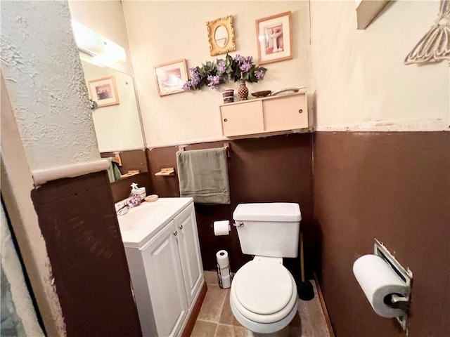 bathroom with tile patterned floors, vanity, and toilet