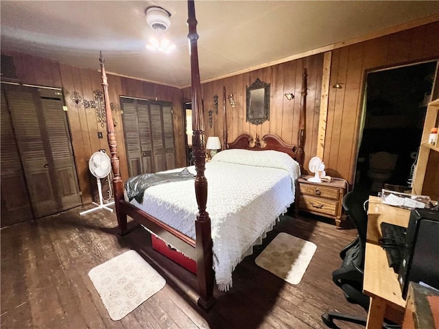 bedroom featuring dark hardwood / wood-style floors, wood walls, and ornamental molding