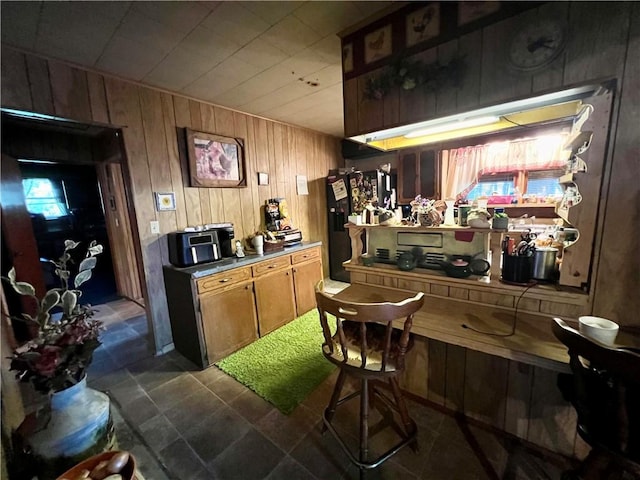 bar with wooden walls and black refrigerator