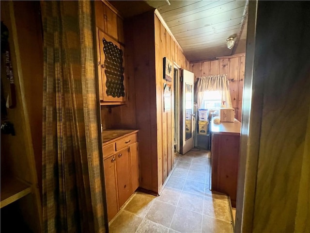 interior space with wood ceiling and wooden walls