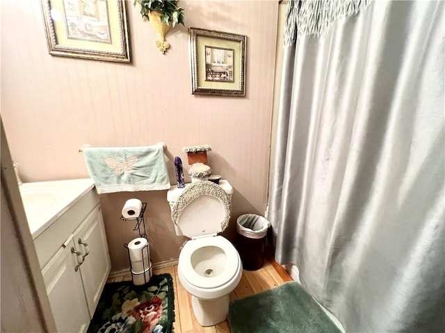 bathroom featuring vanity, hardwood / wood-style flooring, and toilet