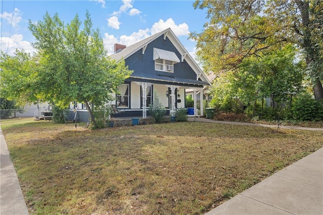 view of front of house with a porch and a front yard