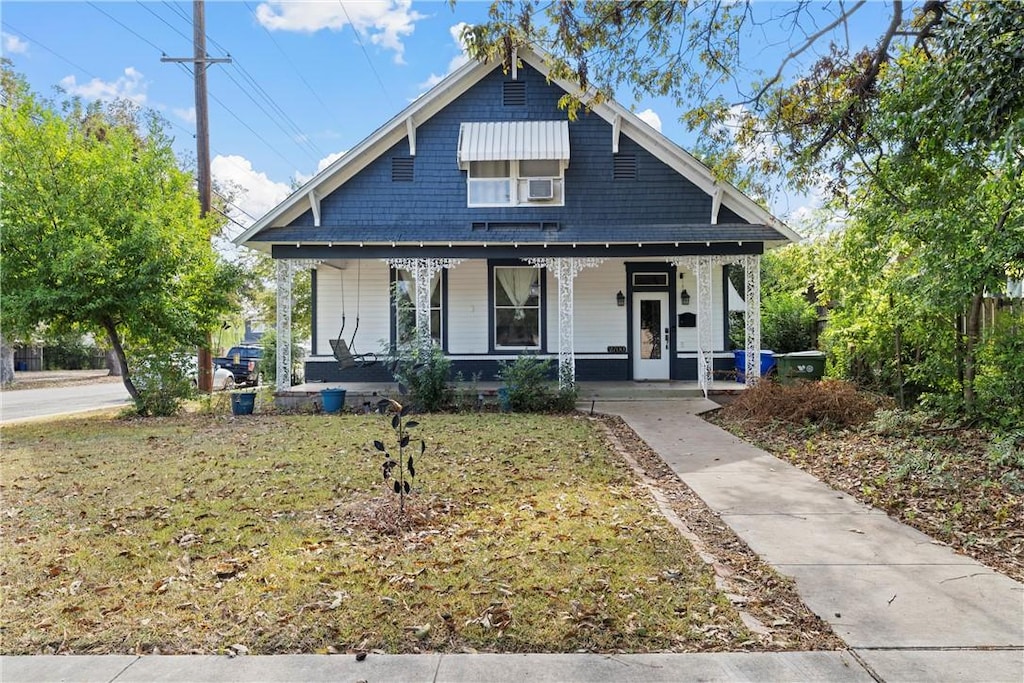 bungalow-style house featuring a porch and a front yard