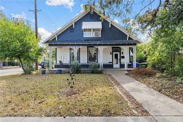 bungalow-style house featuring a porch and a front yard