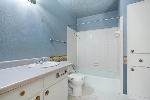 full bathroom featuring tile patterned floors, vanity, a textured ceiling, tiled shower / bath combo, and toilet