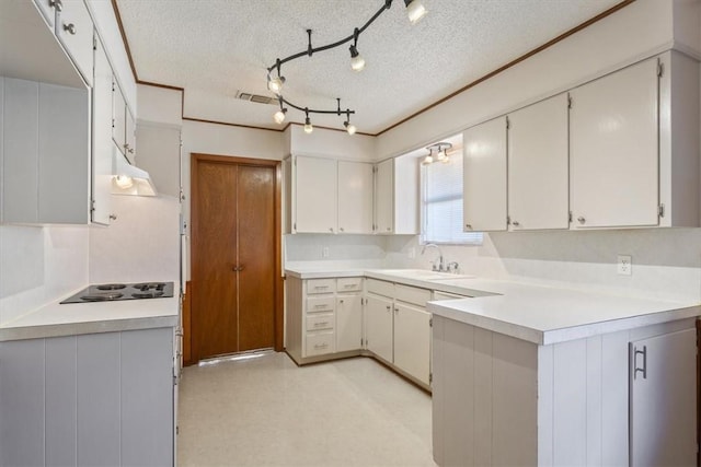 kitchen featuring white cabinetry, sink, black electric cooktop, and a textured ceiling