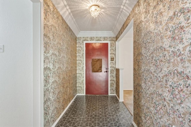 hallway featuring a textured ceiling and crown molding