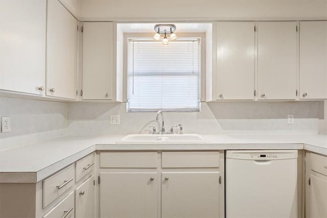 kitchen with dishwasher, white cabinets, tasteful backsplash, and sink