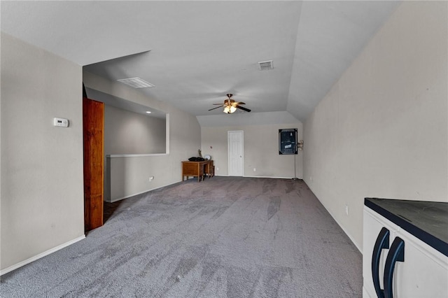 unfurnished living room with carpet floors, vaulted ceiling, and ceiling fan