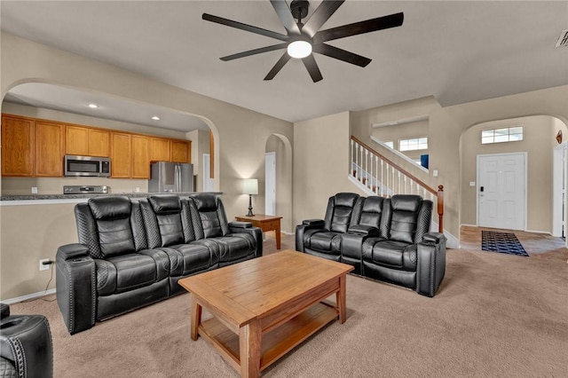 living room with ceiling fan and light colored carpet