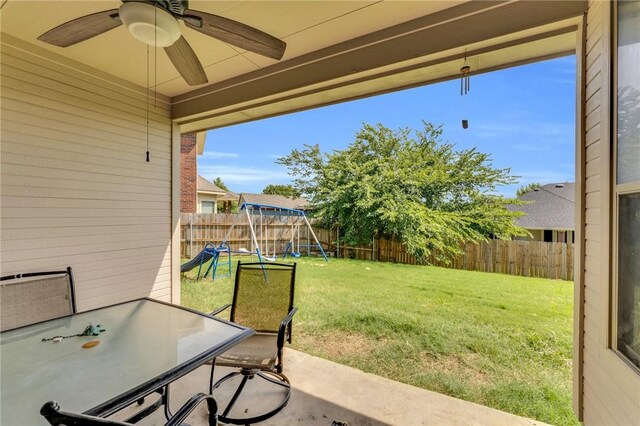 view of yard with a playground, ceiling fan, and a patio