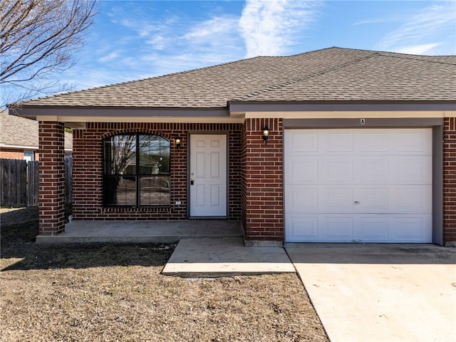 view of front of home with concrete driveway, brick siding, and roof with shingles