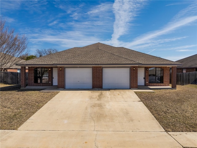 ranch-style home featuring brick siding, roof with shingles, concrete driveway, fence, and a garage