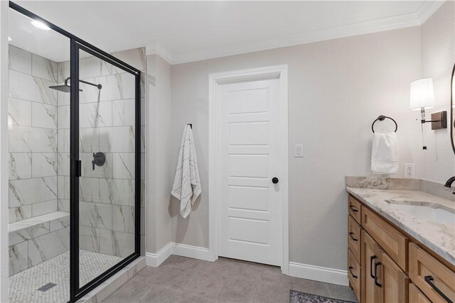 bathroom with crown molding, tile patterned flooring, vanity, and an enclosed shower