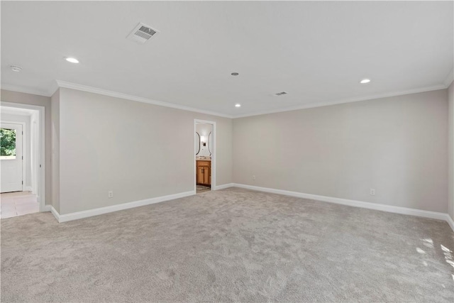 empty room with crown molding and light carpet