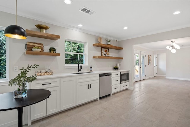 kitchen with white cabinets, plenty of natural light, pendant lighting, and stainless steel appliances