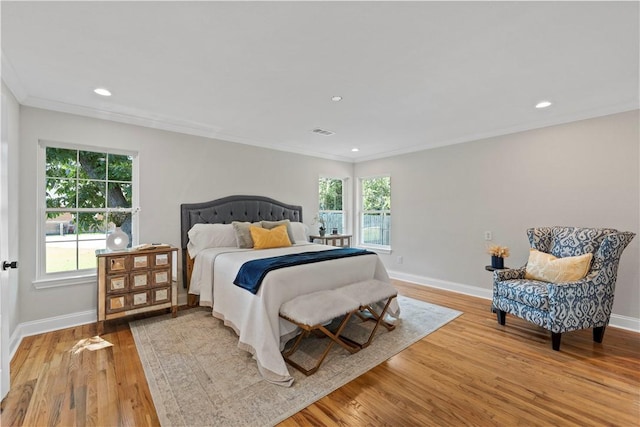 bedroom featuring light hardwood / wood-style floors and ornamental molding