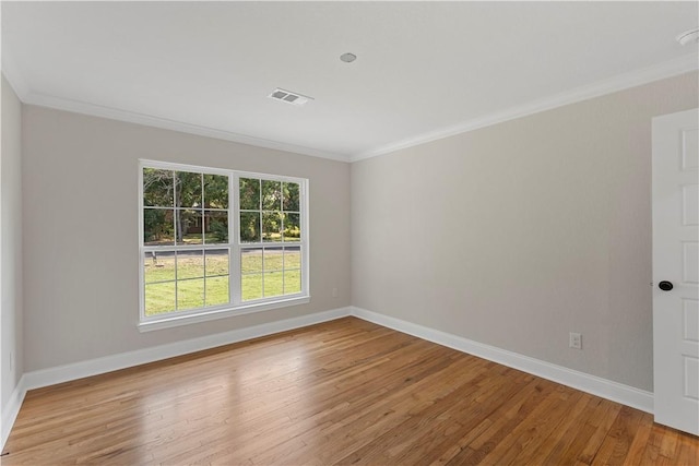 unfurnished room with light hardwood / wood-style floors and crown molding