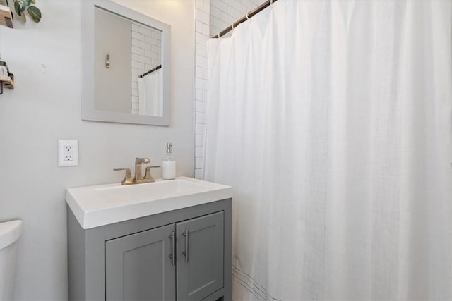 bathroom with toilet and vanity