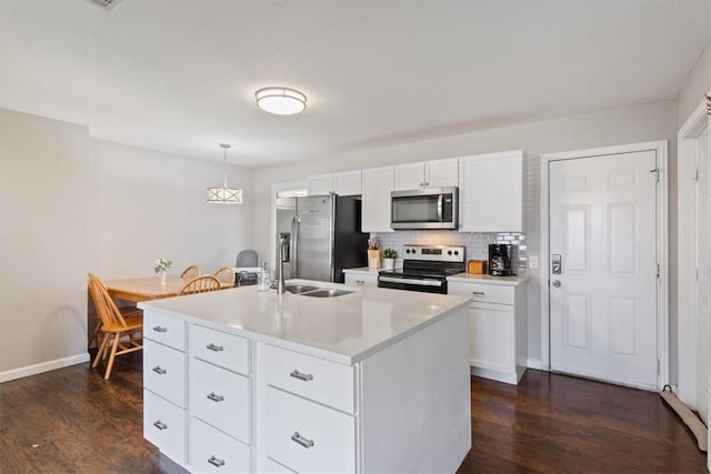 kitchen with dark wood-type flooring, light countertops, backsplash, and stainless steel appliances