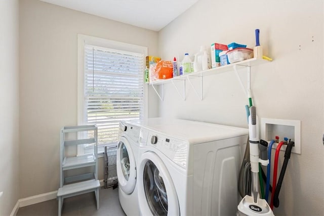 laundry area with baseboards, laundry area, and washer and clothes dryer