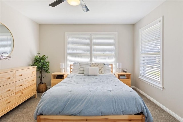 carpeted bedroom featuring baseboards and a ceiling fan