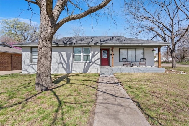 view of front of property with brick siding and a front yard