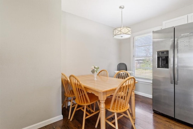 dining area featuring dark wood-style floors and baseboards