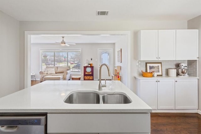 kitchen featuring visible vents, a sink, light countertops, white cabinets, and stainless steel dishwasher