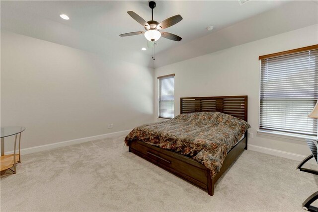 carpeted bedroom with multiple windows and ceiling fan