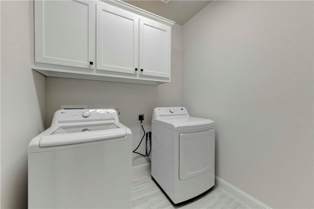 laundry room with cabinets and washer and dryer