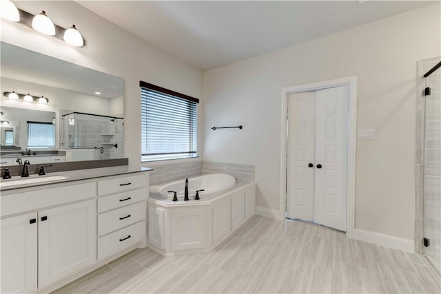 bathroom with vanity and separate shower and tub