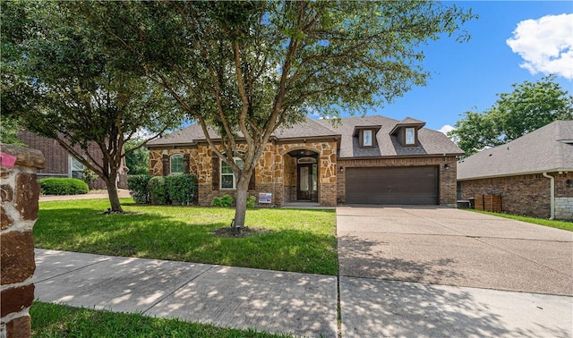 view of front of home featuring a garage and a front lawn