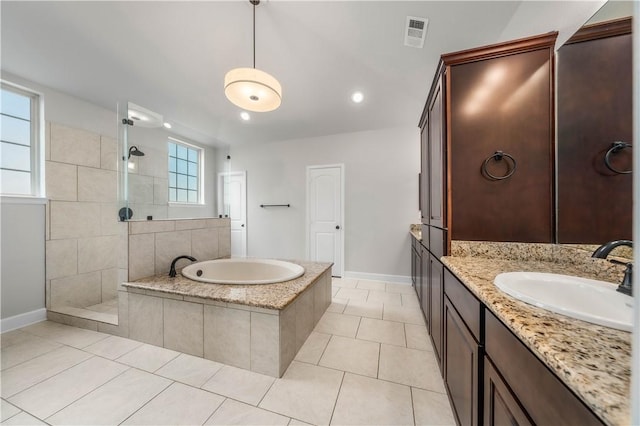 bathroom featuring tile patterned flooring, a wealth of natural light, and independent shower and bath