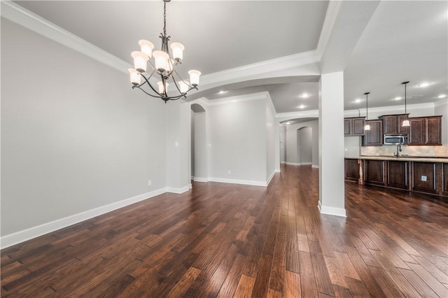 interior space featuring a chandelier, dark hardwood / wood-style floors, and ornamental molding