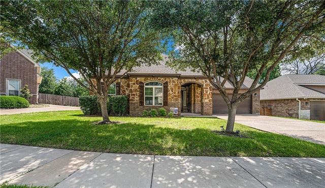 view of front of home featuring a front lawn and a garage