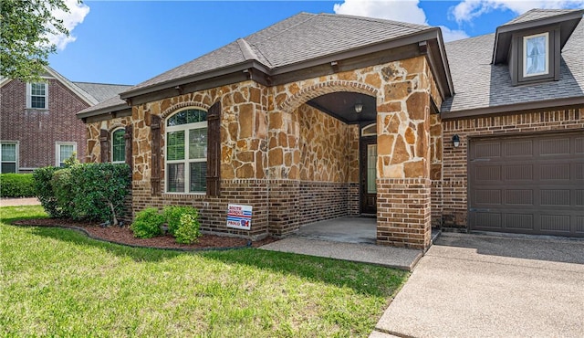 view of front of property featuring a garage and a front lawn