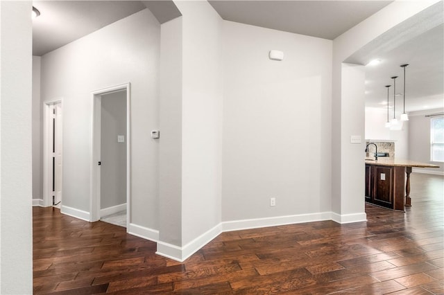 hallway with dark hardwood / wood-style flooring